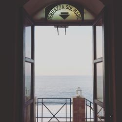 Scenic view of sea against clear sky seen through window