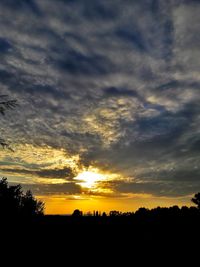 Silhouette landscape against scenic sky