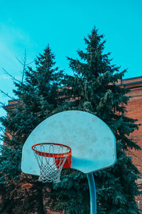 Low angle view of basketball hoop against blue sky