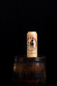 Close-up of coffee cup on table against black background