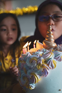Candles on a colourful unicorn birthday cake.