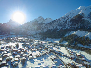 High angle view of houses by snowcapped mountains at kandersteg