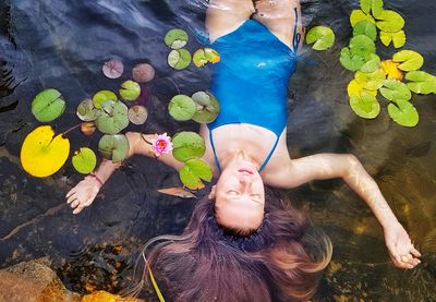 High angle view of mid adult woman relaxing in lake