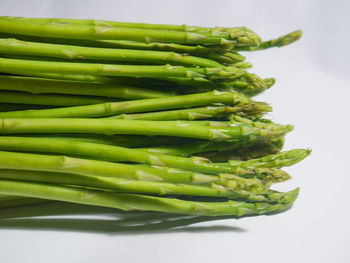 High angle view of green beans against white background