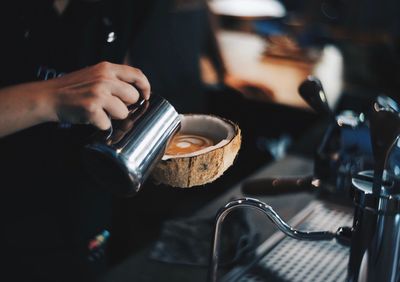Close-up of hand holding coffee cup