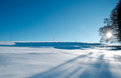 Scenic view of beach against clear blue sky