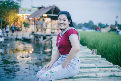 Portrait of smiling woman sitting outdoors