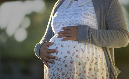 Midsection of woman standing outdoors