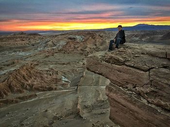 Silhouette of people on rock formation