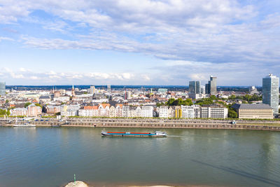 Buildings in city against cloudy sky