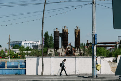 Full length of woman walking on city street