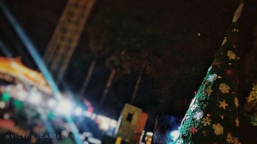 Low angle view of illuminated lights hanging at night