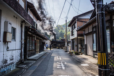 Street amidst buildings against sky