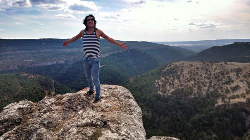 Full length of woman jumping on mountain