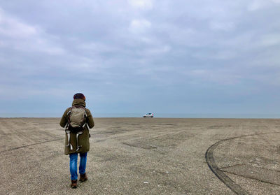 Rear view of man standing on beach