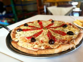 Close-up of pizza served on table