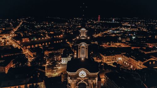 Aerial view of illuminated buildings in city at night