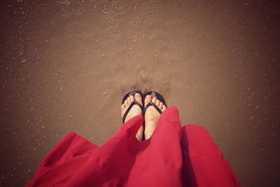 Low section of woman standing on beach