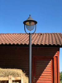 Low angle view of street light against building