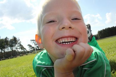 Close-up portrait of smiling boy on field