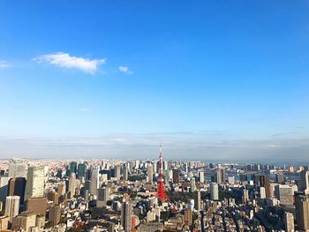 View of cityscape against cloudy sky