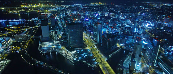 High angle view of illuminated buildings in city at night