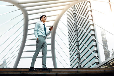 Low angle view of man standing on staircase