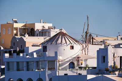 Windmill and traditional white houses - firostefani, santorini, greece