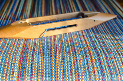 Close-up of wooden equipment on colorful thread