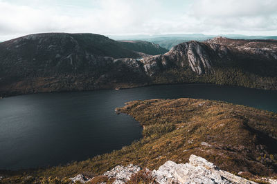 Scenic view of lake by mountain against sky