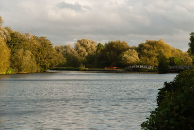 Scenic view of lake against cloudy sky