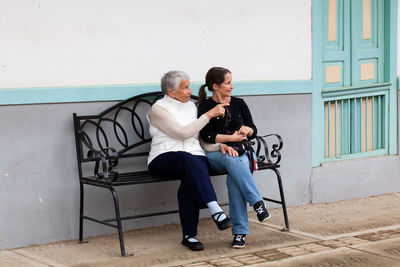 Senior mother and adult daughter traveling together at the small town of salento in colombia