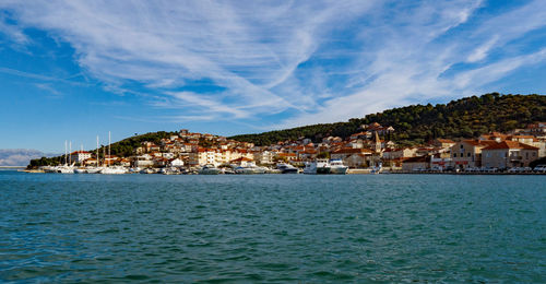 Town by sea against sky