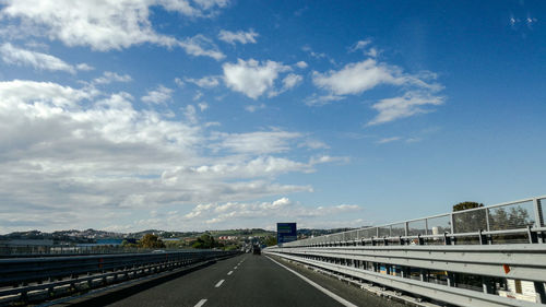 Cars on bridge against sky