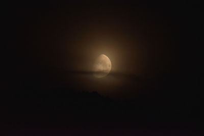 Low angle view of moon in sky at night