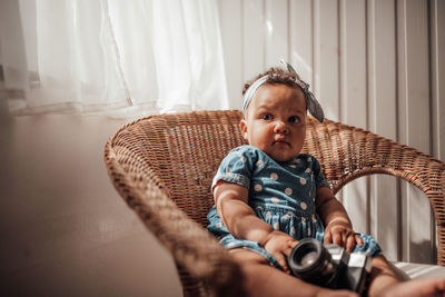 Portrait of cute girl sitting at home