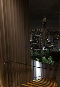 High angle view of illuminated buildings in city at night