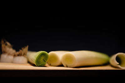 Close-up of vegetables on table against black background