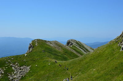 Scenic view of mountains against clear blue sky