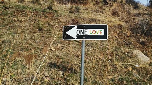 Road sign on field