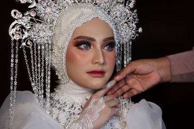 Close-up portrait of young woman in traditional clothing