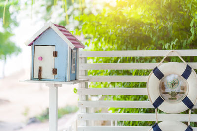 Close-up of birdhouse hanging against building