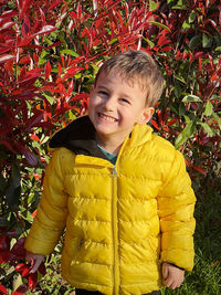 Portrait of boy standing amidst plants