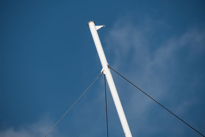 Low angle view of windmill against blue sky