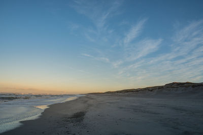 Scenic view of beach against sky during sunset