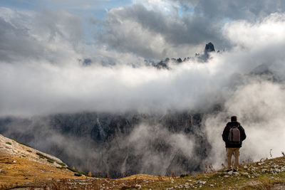 Rear view of man standing on mountain