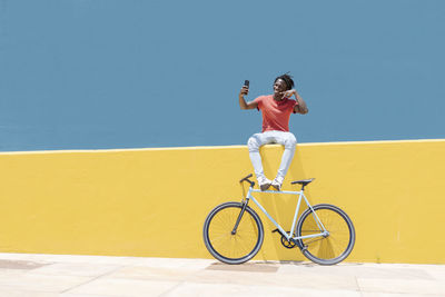 African american guy resting near bicycle