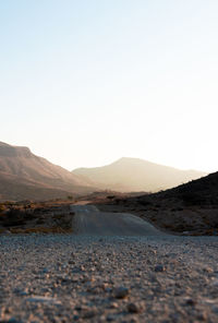 Surface level of road against clear sky