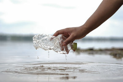 Close-up of hand holding water