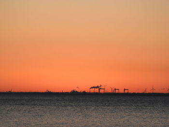 Scenic view of sea against clear sky during sunset